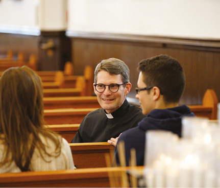  Fr. Morgan Rice, CSB, pastor at St. Basil’s Church, seen here with St. Mike’s students. 