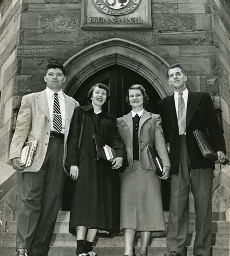 Fr. Kelly and guests at the William McElcheran statue unveiling in front of the Kelly Library in 1973.